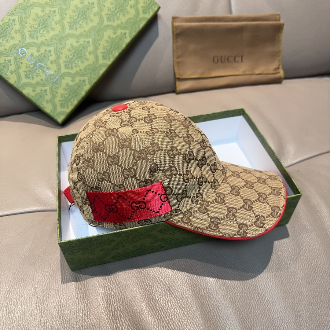 Gucci baseball cap with GG monogram fabric, red interior patch, and curved brim.
