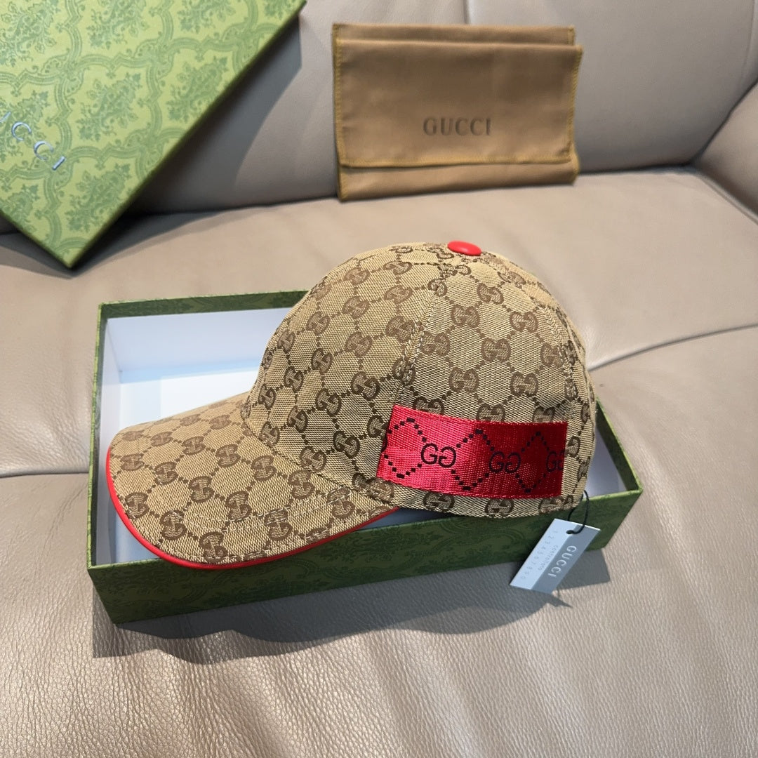 Gucci baseball cap with GG monogram print, red side panel, and red top button.