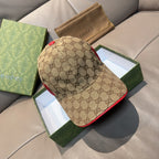 Gucci baseball cap in brown canvas with GG monogram pattern and red contrast trim.