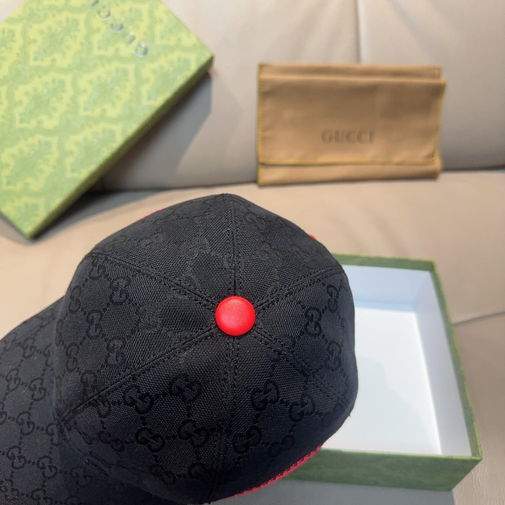 Gucci dark navy baseball cap with GG pattern and red top button