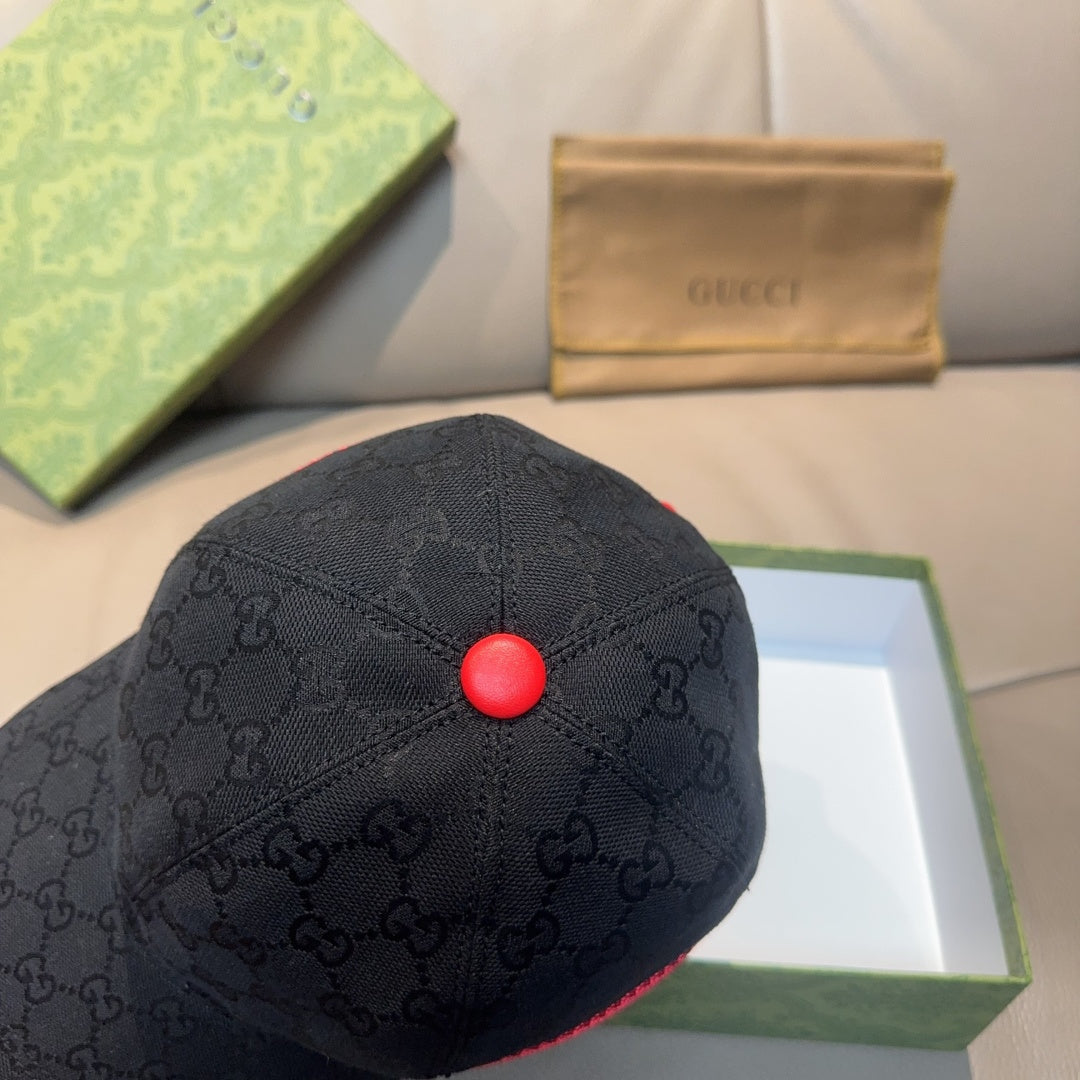 Gucci dark navy baseball cap with GG pattern and red top button