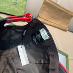 Gucci dark navy cap with red-edged strap and interior label tags