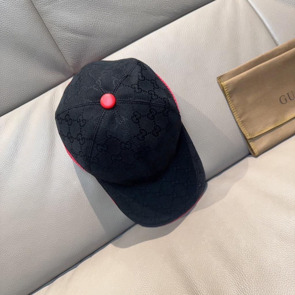 Gucci dark navy baseball cap with GG pattern and red top button