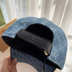 Blue monogram cap with black adjustable buckle strap inside opening.