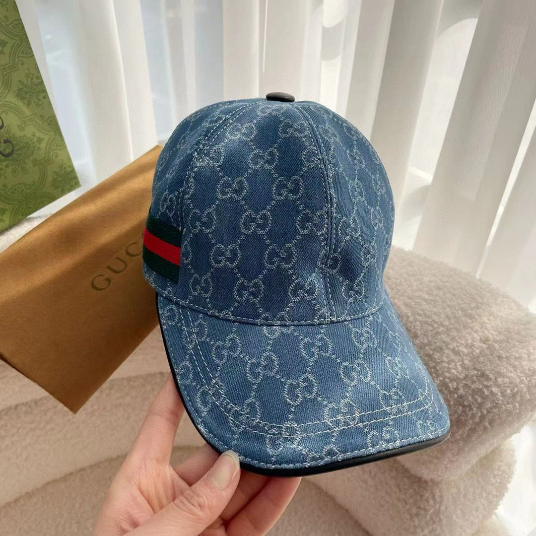 Blue monogram baseball cap, back view, with green and red stripe across the band.