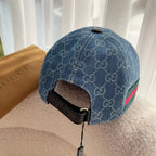 Blue monogram cap back angle with green-red web stripe and black adjustable strap.