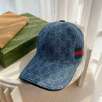 Blue denim-style Gucci monogram baseball cap with green-red web stripe detail.