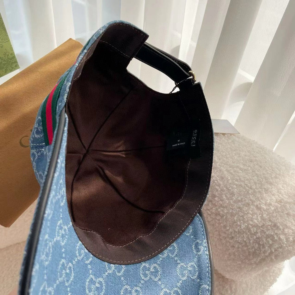 Blue monogram cap interior view with black lining and adjustable strap.