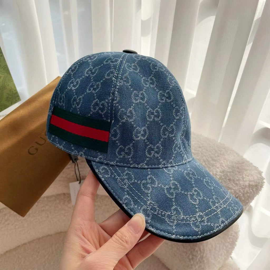 Blue monogram baseball cap side view with green and red web stripe at the band.