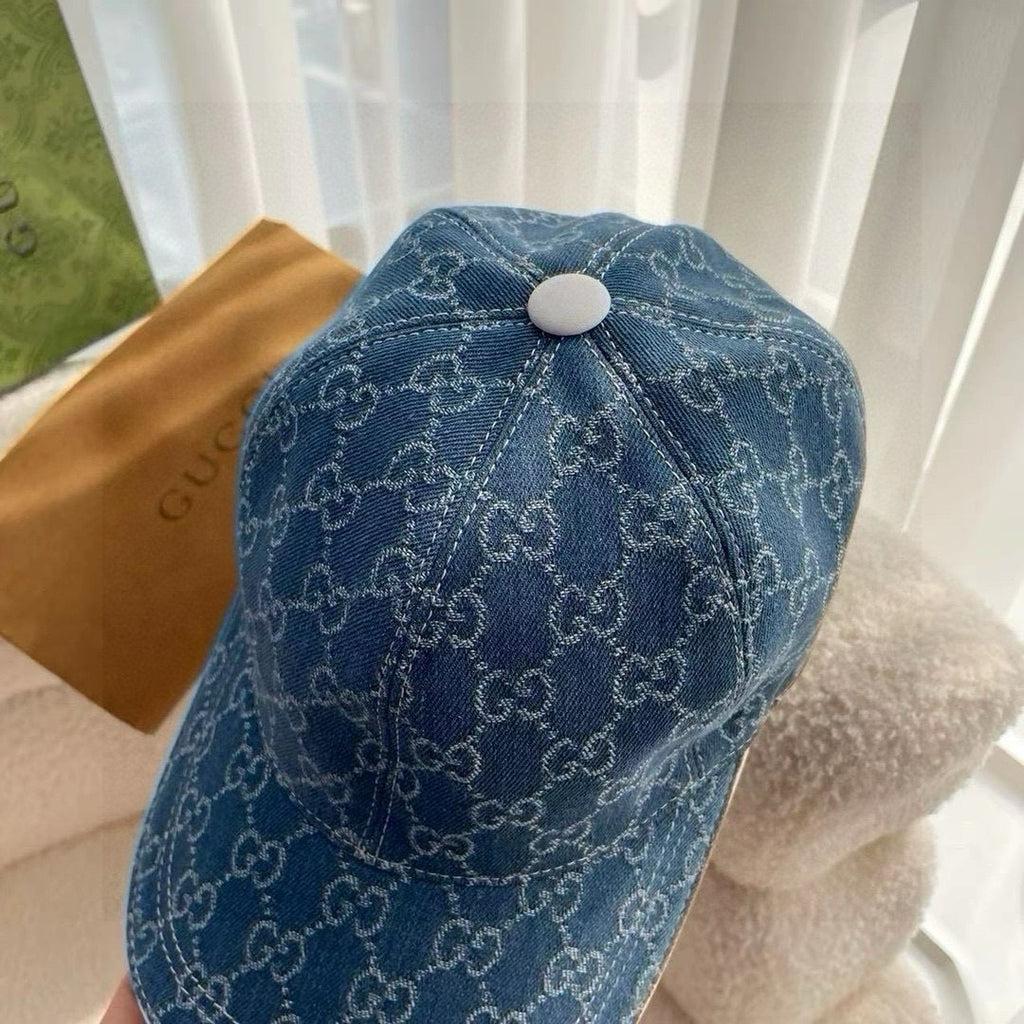 Blue Gucci monogram baseball cap with round top button and curved brim