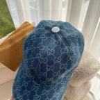 Blue Gucci monogram baseball cap with round top button and curved brim