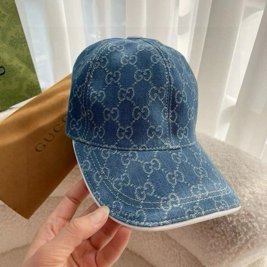 Blue Gucci monogram baseball cap with curved brim and visible stitching