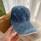 Blue Gucci monogram baseball cap with curved brim and visible stitching