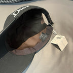 Black Dior cap interior view with fabric lining and attached size tag