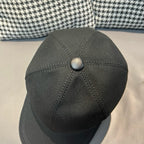 Black Dior cap top view with round button and stitched crown seams