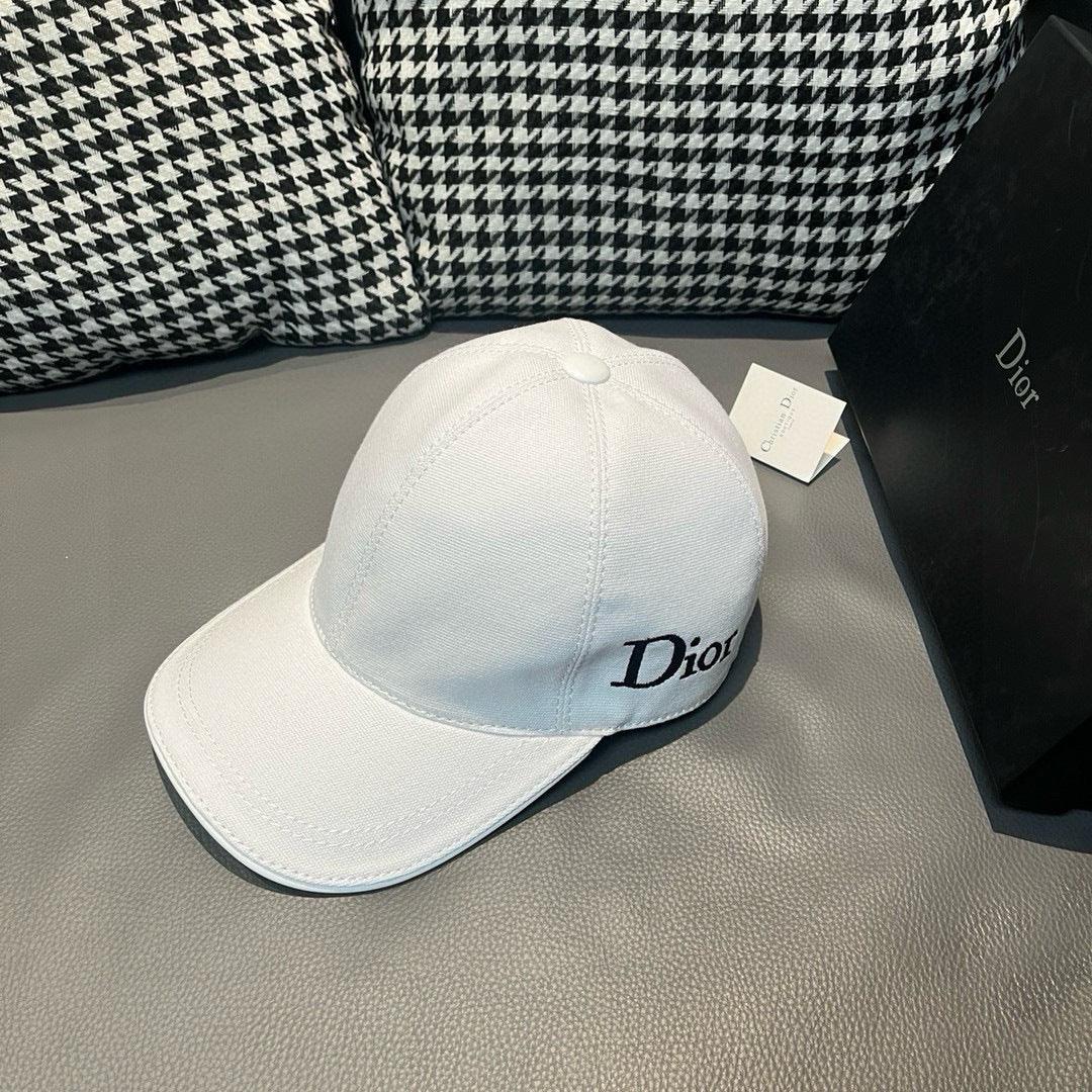 Dior cap in white canvas with curved brim and stitched crown paneling.