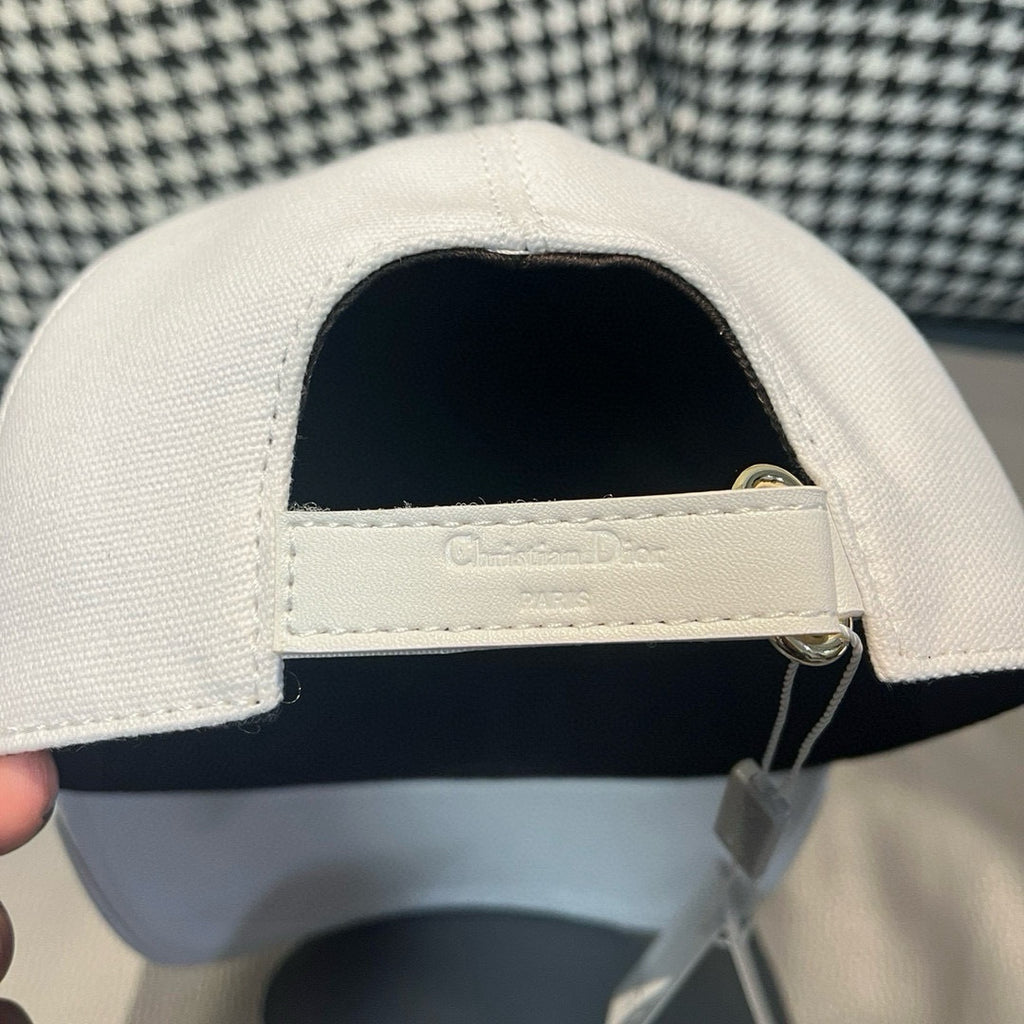 Dior cap interior with adjustable strap and gold ring hardware.