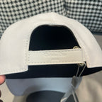 Dior cap interior with adjustable strap and gold ring hardware.
