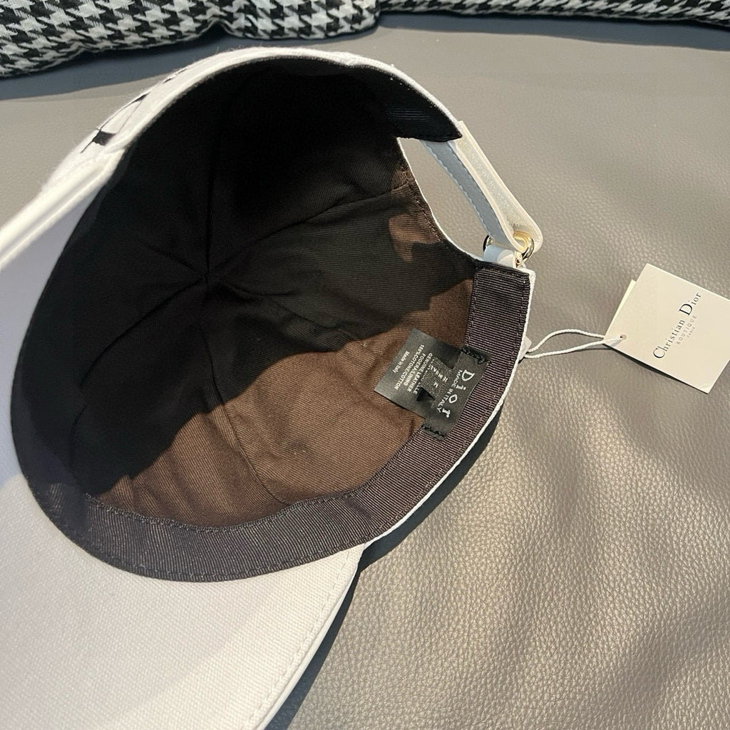 Dior cap in white canvas showing interior lining and adjustable strap.
