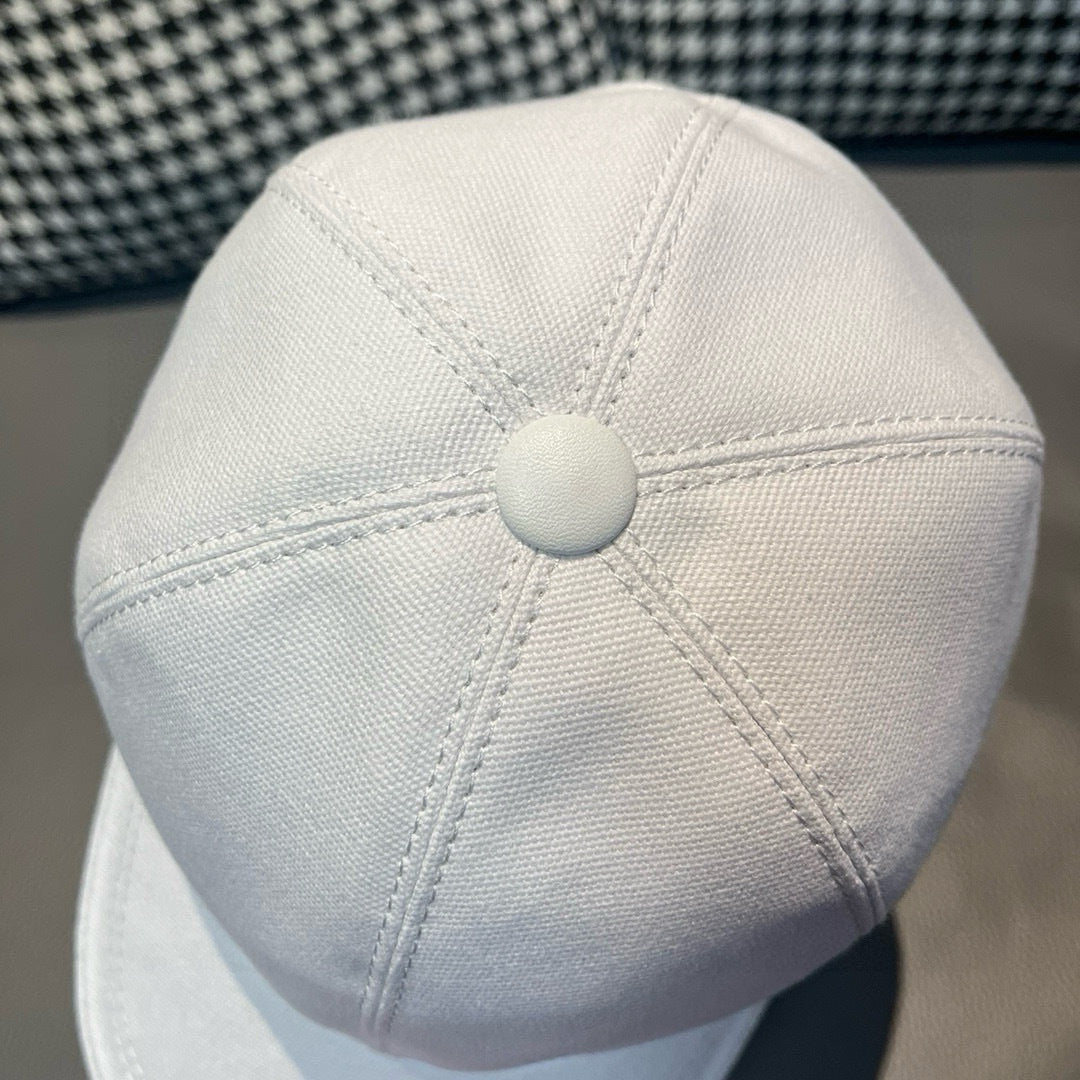 Dior cap in white canvas with round top button and stitched vent panels.