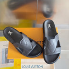 Louis Vuitton slide sandals, dark gray leather, with LV logo on the footbed.