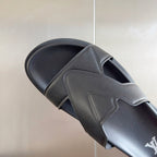 Louis Vuitton dark gray slide sandal with textured upper strap and LV logo on side.