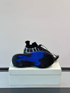 Burberry sneakers outsole view with bold blue tread and black check upper
