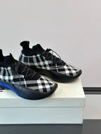 Burberry sneakers close-up showing black-and-white check upper and blue sole edge