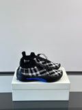 Burberry sneakers with black-and-white check knit upper and blue accent sole