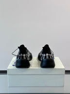 Burberry sneakers showing back heel area in black-and-white check with blue sole
