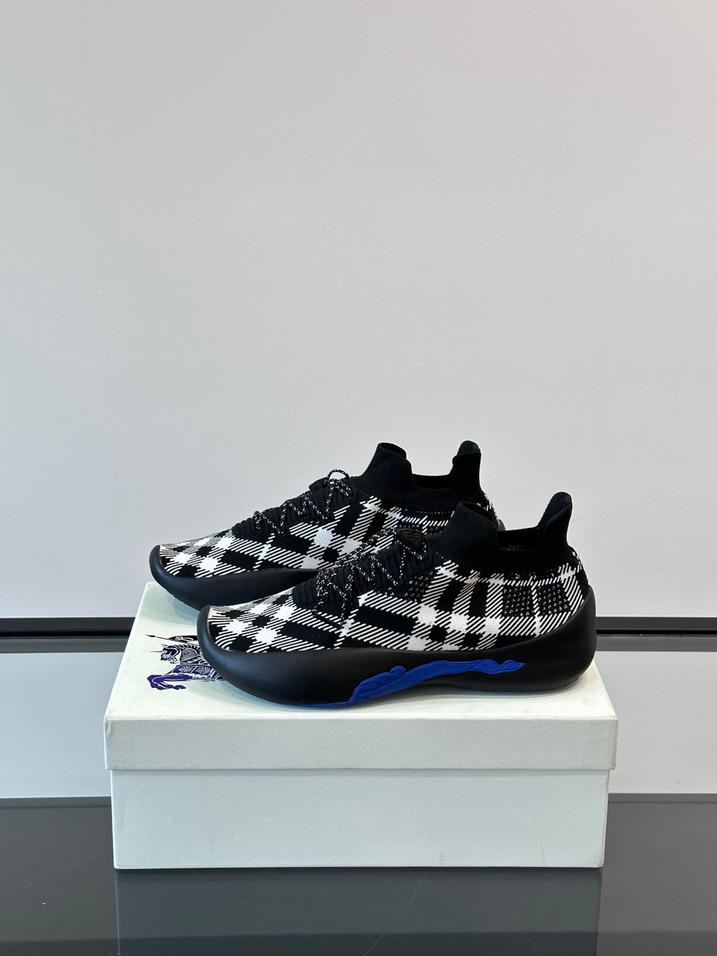 Burberry sneakers in black-and-white check with blue underlay detail on outsole