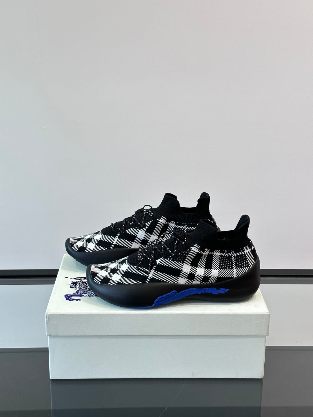 Burberry sneakers in black-and-white check with blue underlay detail on outsole
