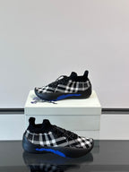 Burberry sneakers with black-and-white check upper and blue trim along sole