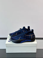 Blue plaid slip-on sneaker with elastic lace detail and black outsole with blue accent