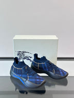 Blue plaid sneakers on white box, showing front and side profile with blue outsole