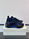 Blue slip-on sneakers with plaid knit upper, elastic laces, and black rubber sole