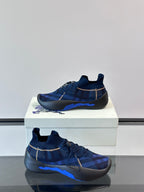 Side view of navy plaid sneakers with pull-tab collar, elastic laces, and blue outsole stripe