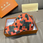 Plaid baseball cap in orange, green, black, and white with LV monogram patch