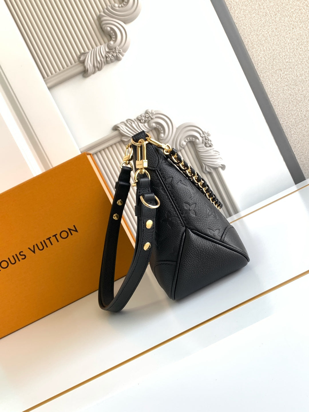 Louis Vuitton black leather shoulder bag with gold chain strap and top handle loop