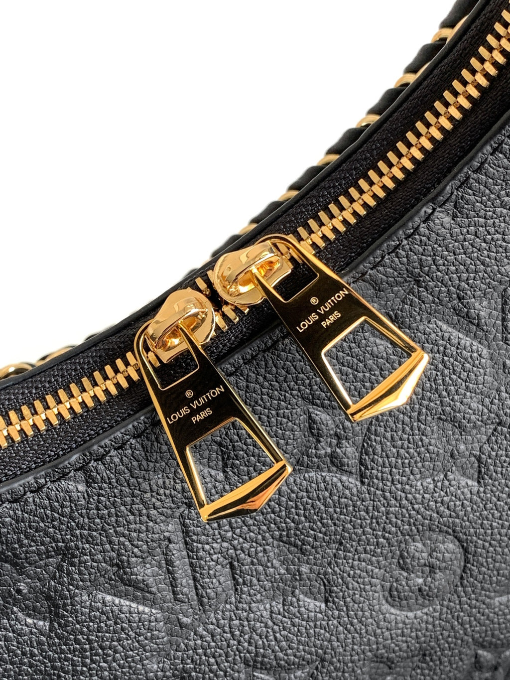Louis Vuitton black monogram bag close-up of gold zipper pulls and hardware