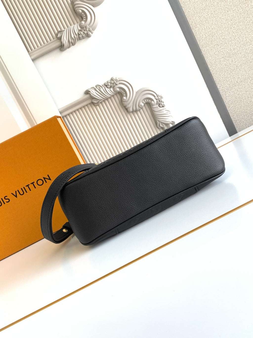 Louis Vuitton black leather shoulder bag with gold zipper and adjustable strap