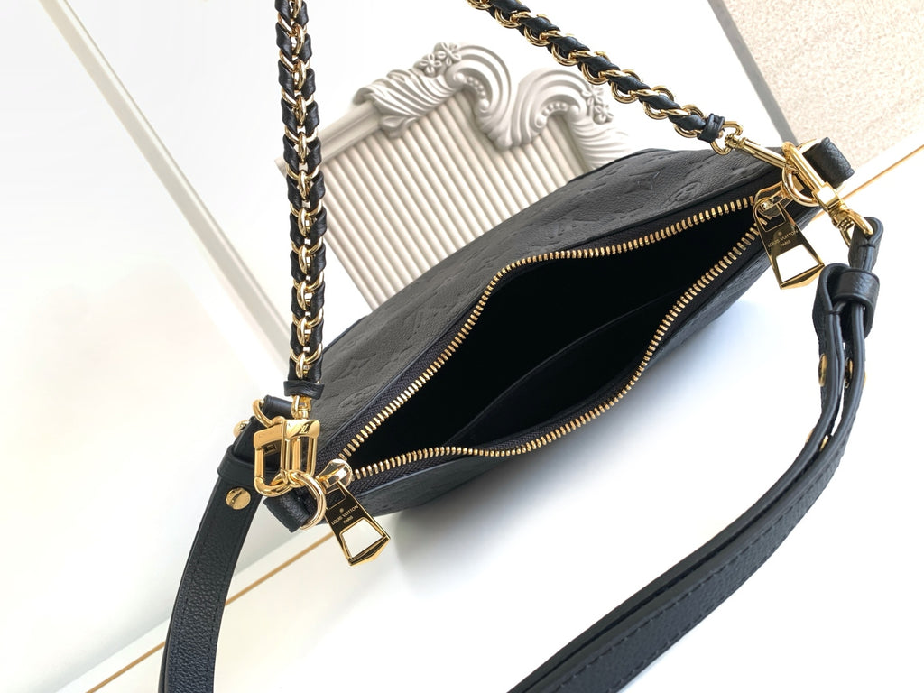 Louis Vuitton black monogram bag open view showing interior and gold zipper hardware