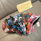 Louis Vuitton cap with multicolor check pattern in red, blue, green, and black, side view.