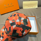 Louis Vuitton cap with orange and multicolor check pattern on the crown, button-style top.