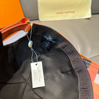Louis Vuitton cap interior and strap with hang tags, showing dark lining and stitching.