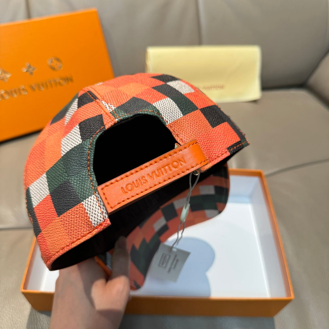 Louis Vuitton cap with orange geometric check panel and black underside, open front view.