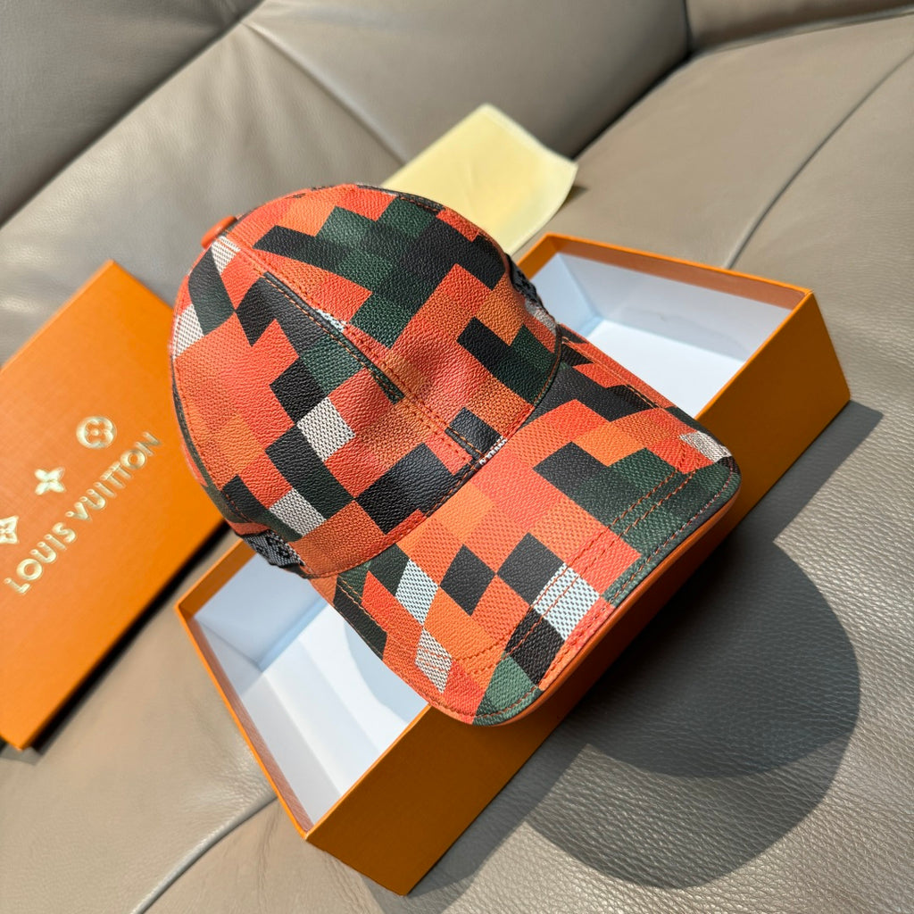 Louis Vuitton cap with orange, green, and black geometric check pattern, curved brim.