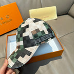 Louis Vuitton plaid baseball cap in cream, green, and brown squares with black accents