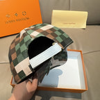 Louis Vuitton cap with green, cream, and brown plaid panels and a white inner strap