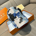 Louis Vuitton cap in blue, black, and white checkered canvas with curved brim.